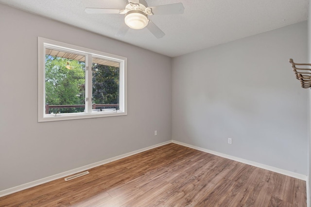 549 Vicki Ln, Shoreview, MN 55126 - unfurnished room with wood finished floors, a ceiling fan, and a textured ceiling