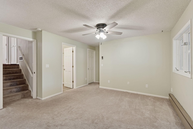 549 Vicki Ln, Shoreview, MN 55126 - carpeted empty room featuring baseboard heating, ceiling fan, stairway, and a textured ceiling