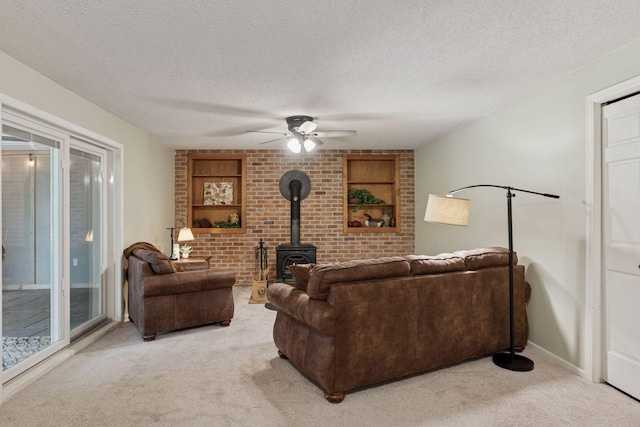 549 Vicki Ln, Shoreview, MN 55126 - living area featuring light colored carpet, a textured ceiling, a wood stove, and a ceiling fan