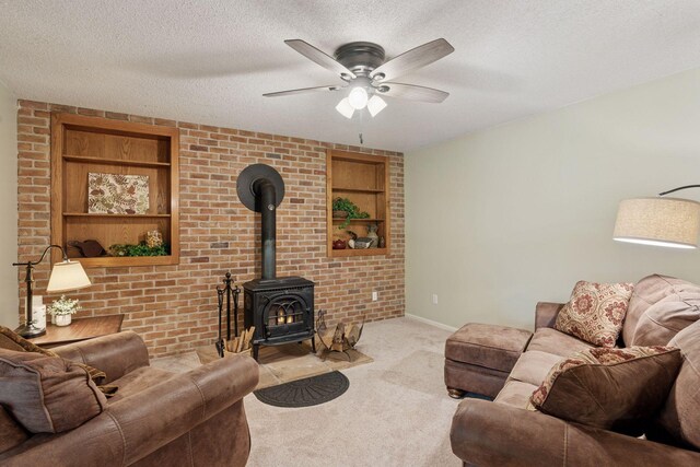 549 Vicki Ln, Shoreview, MN 55126 - living area featuring carpet flooring, a wood stove, ceiling fan, built in features, and a textured ceiling