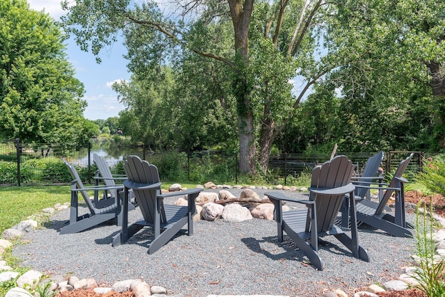 549 Vicki Ln, Shoreview, MN 55126 - view of yard with an outdoor fire pit, view of wooded area, and a water view