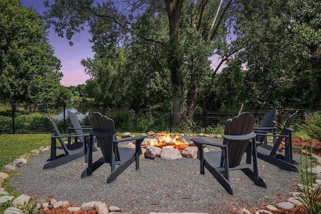 549 Vicki Ln, Shoreview, MN 55126 - yard at dusk with an outdoor fire pit and view of wooded area