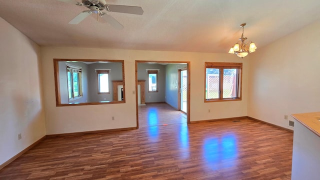 9136 Windsor Ter, Brooklyn Park, MN 55443 - empty room with wood finished floors, a chandelier, and a ceiling fan