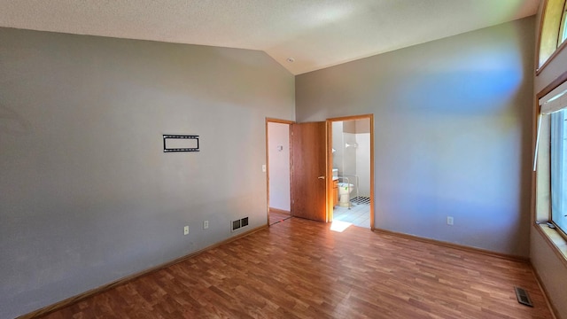 9136 Windsor Ter, Brooklyn Park, MN 55443 - spare room with high vaulted ceiling and wood finished floors