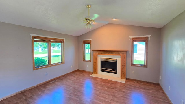 9136 Windsor Ter, Brooklyn Park, MN 55443 - unfurnished living room featuring ceiling fan, wood finished floors, lofted ceiling, and a fireplace with flush hearth