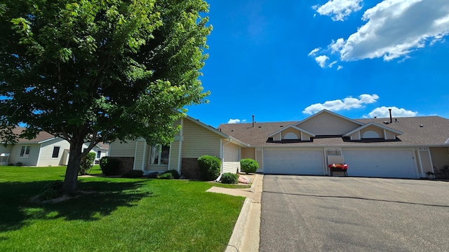 9136 Windsor Ter, Brooklyn Park, MN 55443 - view of front of home with concrete driveway, a garage, a front lawn, and brick siding