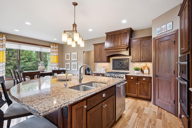 7461 Merrimac Ln N, Maple Grove, MN 55311 - kitchen with premium range hood, a kitchen bar, stainless steel dishwasher, pendant lighting, and light wood-style flooring