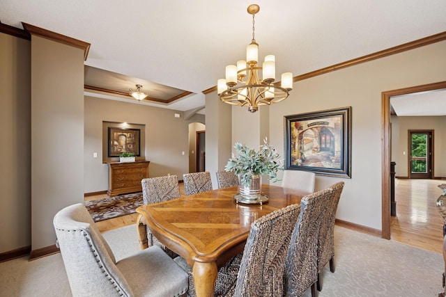 7461 Merrimac Ln N, Maple Grove, MN 55311 - dining area featuring arched walkways, a chandelier, light wood-style floors, ornamental molding, and a tray ceiling