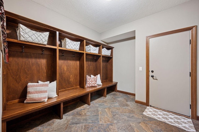 7461 Merrimac Ln N, Maple Grove, MN 55311 - mudroom featuring a textured ceiling and stone finish flooring