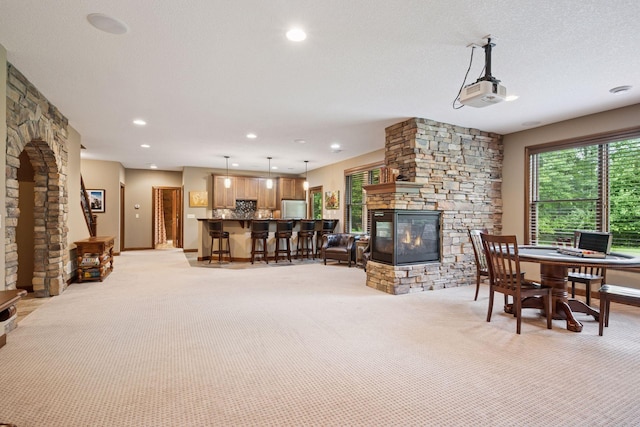7461 Merrimac Ln N, Maple Grove, MN 55311 - living room featuring light colored carpet, a stone fireplace, and recessed lighting