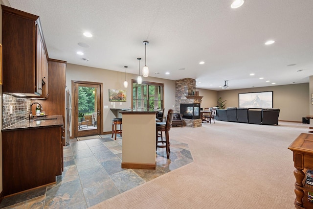 7461 Merrimac Ln N, Maple Grove, MN 55311 - dining area featuring recessed lighting, a stone fireplace, stone tile floors, and carpet