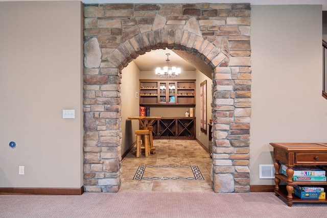 7461 Merrimac Ln N, Maple Grove, MN 55311 - wine area with arched walkways, a chandelier, and carpet floors