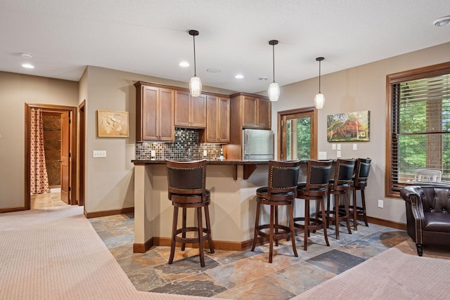 7461 Merrimac Ln N, Maple Grove, MN 55311 - kitchen featuring freestanding refrigerator, stone tile flooring, decorative backsplash, healthy amount of natural light, and recessed lighting