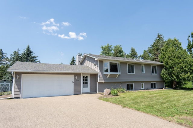 1781 Taconite Pt, Eagan, MN 55122 - tri-level home with a chimney, a front yard, an attached garage, and driveway