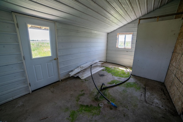 43724 County Highway 19, Blowers Twp, MN 56477 - interior space featuring lofted ceiling, unfinished concrete flooring, and wood walls