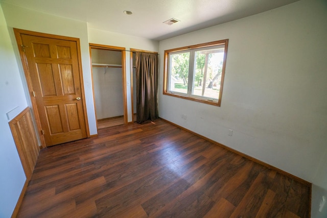 43724 County Highway 19, Blowers Twp, MN 56477 - unfurnished bedroom with dark wood-type flooring and baseboards