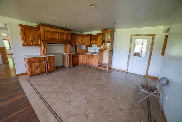 43724 County Highway 19, Blowers Twp, MN 56477 - kitchen featuring brown cabinets, glass insert cabinets, light countertops, and recessed lighting