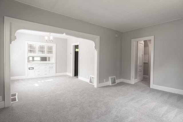 4020 Emerson Ave N, Minneapolis, MN 55412 - unfurnished room featuring a chandelier, carpet floors, and arched walkways