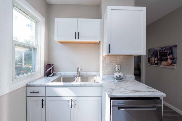 1702 Minnehaha Ave W, Saint Paul, MN 55104 - kitchen with white cabinets, dishwasher, wood finished floors, and a textured wall