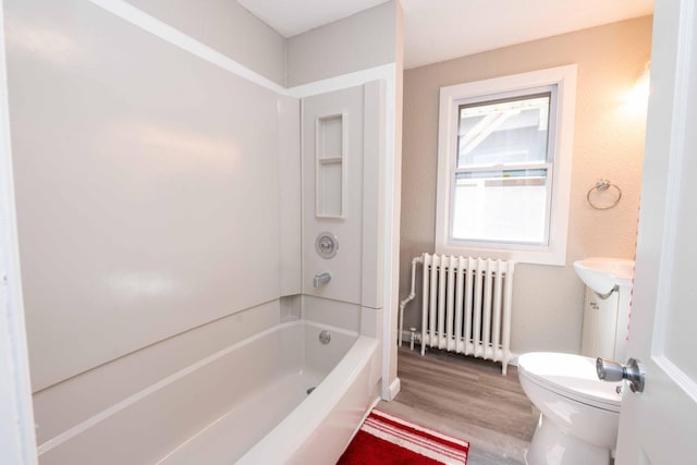 1702 Minnehaha Ave W, Saint Paul, MN 55104 - full bath with radiator heating unit, wood finished floors, vanity, washtub / shower combination, and a textured wall