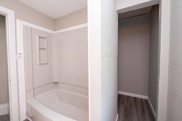 1702 Minnehaha Ave W, Saint Paul, MN 55104 - bathroom with wood finished floors, a textured wall, and shower / bathtub combination