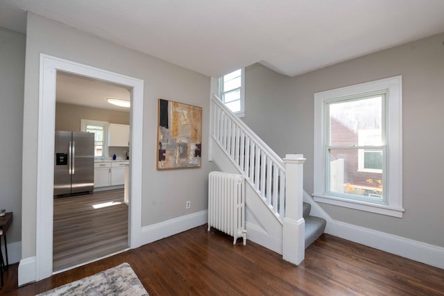 1702 Minnehaha Ave W, Saint Paul, MN 55104 - stairs featuring radiator heating unit, wood finished floors, and plenty of natural light