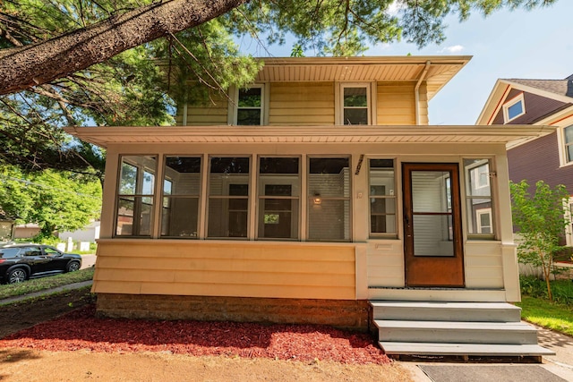 1702 Minnehaha Ave W, Saint Paul, MN 55104 - view of front of house featuring entry steps and a sunroom