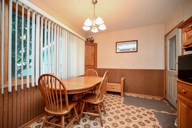 1314 Parkview Ave, Winona, MN 55987 - dining room featuring a chandelier, a wainscoted wall, and wooden walls