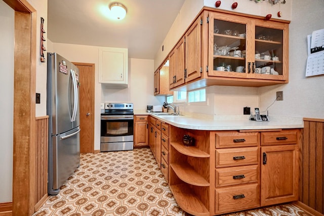 1314 Parkview Ave, Winona, MN 55987 - kitchen featuring appliances with stainless steel finishes, light countertops, open shelves, glass insert cabinets, and brown cabinets