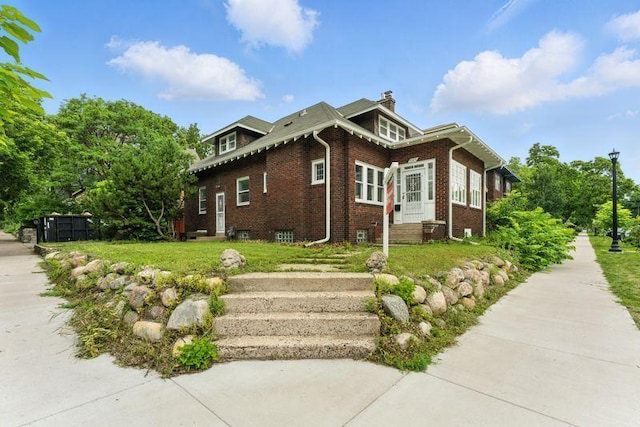 3148 Bryant Ave S, Minneapolis, MN 55408 - view of side of home featuring brick siding, a chimney, and entry steps