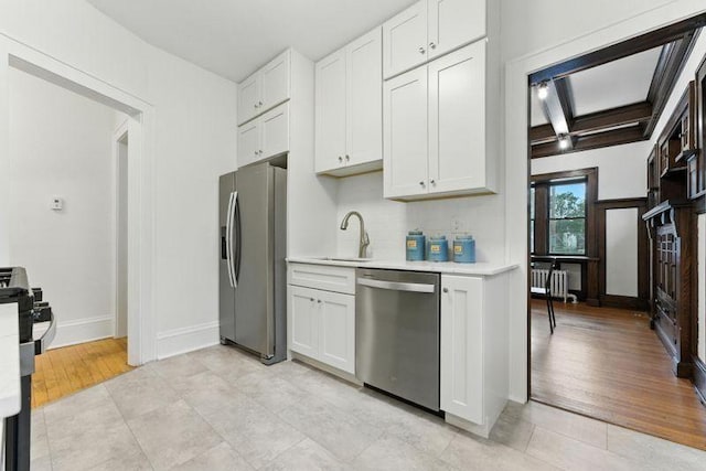 3148 Bryant Ave S, Minneapolis, MN 55408 - kitchen featuring appliances with stainless steel finishes, light countertops, white cabinetry, and light tile patterned flooring