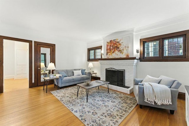 3148 Bryant Ave S, Minneapolis, MN 55408 - living area with crown molding, a fireplace, and light wood finished floors