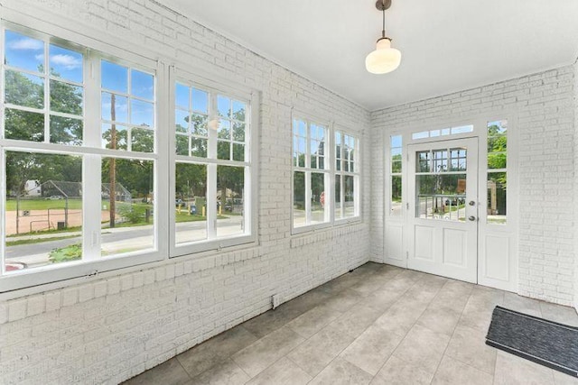 3148 Bryant Ave S, Minneapolis, MN 55408 - unfurnished sunroom with brick wall