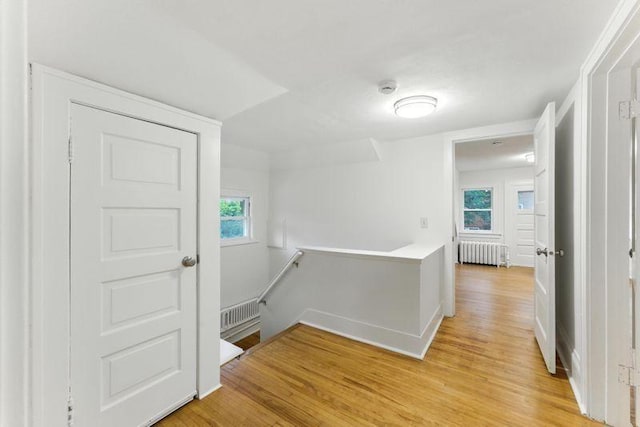 3148 Bryant Ave S, Minneapolis, MN 55408 - hallway featuring radiator, an upstairs landing, and light wood-style floors