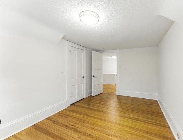 3148 Bryant Ave S, Minneapolis, MN 55408 - unfurnished bedroom with a textured ceiling and light wood-style floors