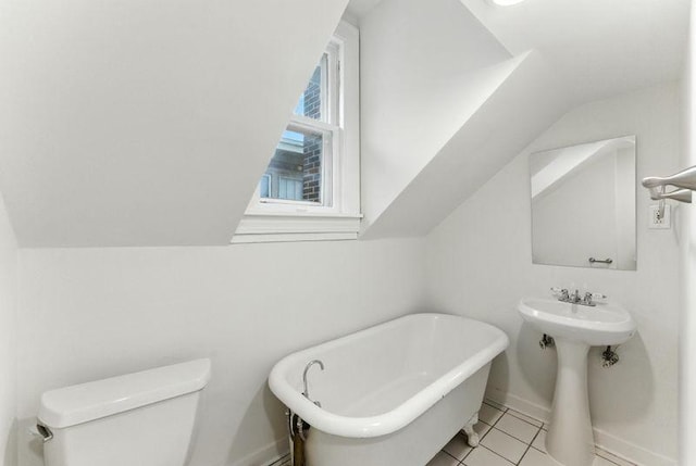 3148 Bryant Ave S, Minneapolis, MN 55408 - full bathroom with lofted ceiling, a freestanding tub, and tile patterned floors