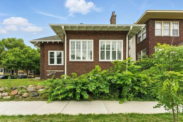 3148 Bryant Ave S, Minneapolis, MN 55408 - view of property exterior featuring a chimney and brick siding
