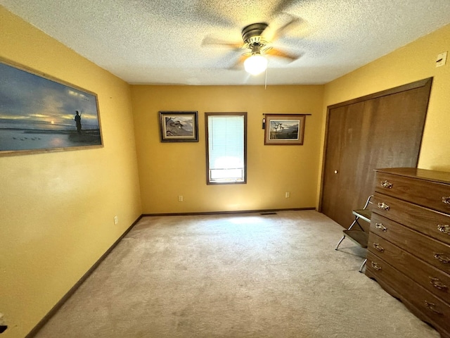 600 Gilbert Ave S, Park Rapids, MN 56470 - unfurnished bedroom with light colored carpet, a closet, a textured ceiling, and ceiling fan