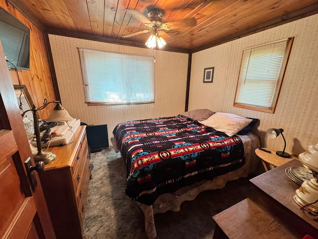 600 Gilbert Ave S, Park Rapids, MN 56470 - carpeted bedroom with wooden ceiling, wallpapered walls, a ceiling fan, and ornamental molding