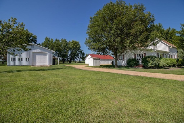 41072 280th St, Arlington Twp, MN 55307 - view of grassy yard with an outbuilding, a garage, and dirt driveway