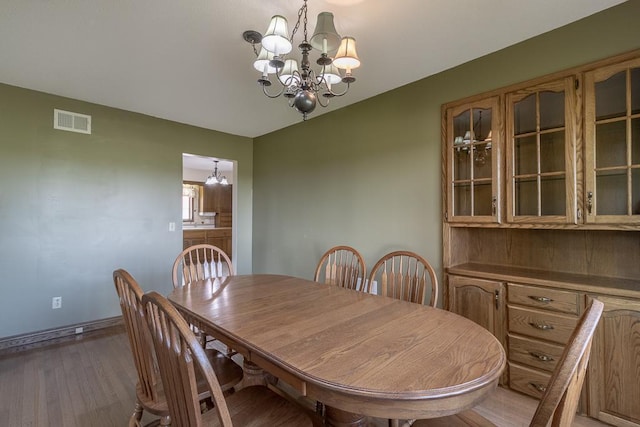 41072 280th St, Arlington Twp, MN 55307 - dining area featuring a chandelier and light wood-style floors