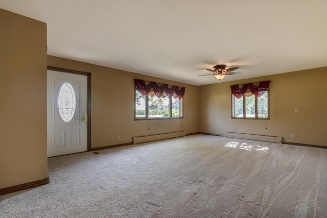 41072 280th St, Arlington Twp, MN 55307 - carpeted entryway featuring baseboard heating, ceiling fan, and a textured ceiling