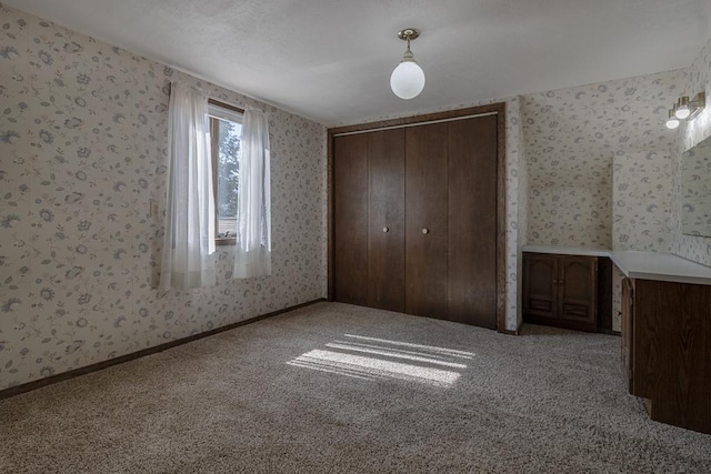 41072 280th St, Arlington Twp, MN 55307 - unfurnished bedroom featuring wallpapered walls, carpet flooring, and a closet