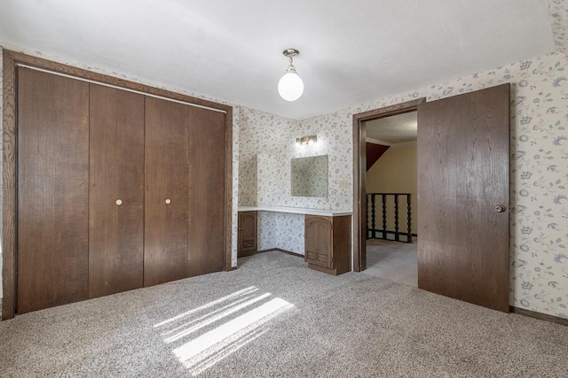 41072 280th St, Arlington Twp, MN 55307 - unfurnished bedroom featuring wallpapered walls, carpet floors, and a closet