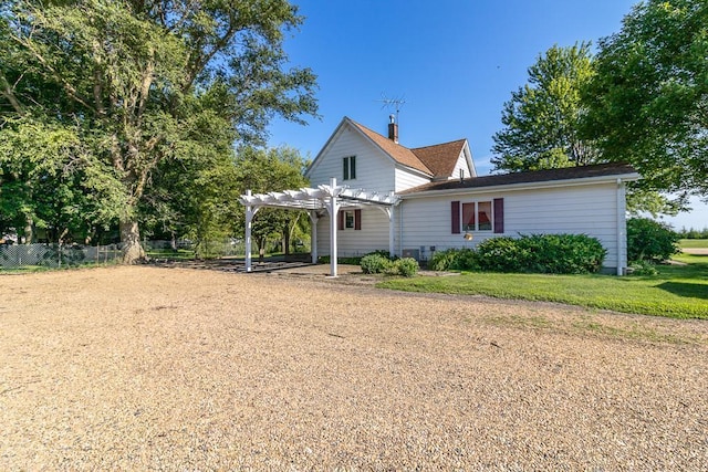 41072 280th St, Arlington Twp, MN 55307 - rear view of property featuring a pergola, a chimney, and a carport
