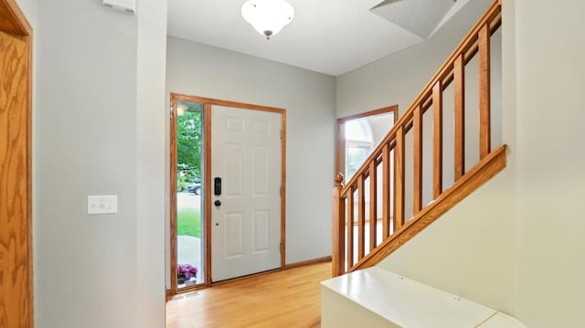2907 Asarum Ct, Shakopee, MN 55379 - entrance foyer with healthy amount of natural light, light wood-style flooring, and stairs