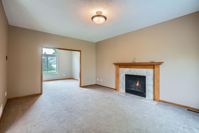 2907 Asarum Ct, Shakopee, MN 55379 - unfurnished living room featuring light colored carpet, a textured ceiling, and a tile fireplace