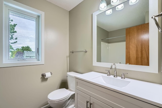 2907 Asarum Ct, Shakopee, MN 55379 - bathroom featuring vanity, a shower, and a textured ceiling