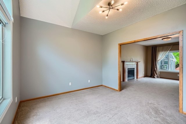 2907 Asarum Ct, Shakopee, MN 55379 - unfurnished room with carpet flooring, a textured ceiling, a fireplace, and a chandelier