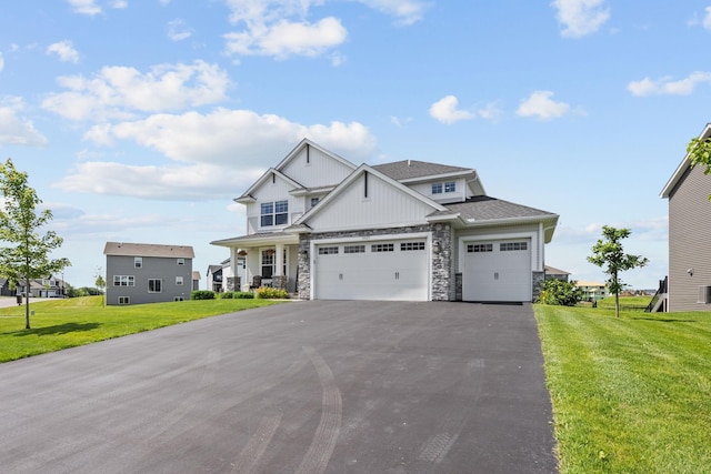 5027 Jansen Ave NE, Saint Michael, MN 55376 - craftsman house featuring stone siding, driveway, a front yard, and roof with shingles